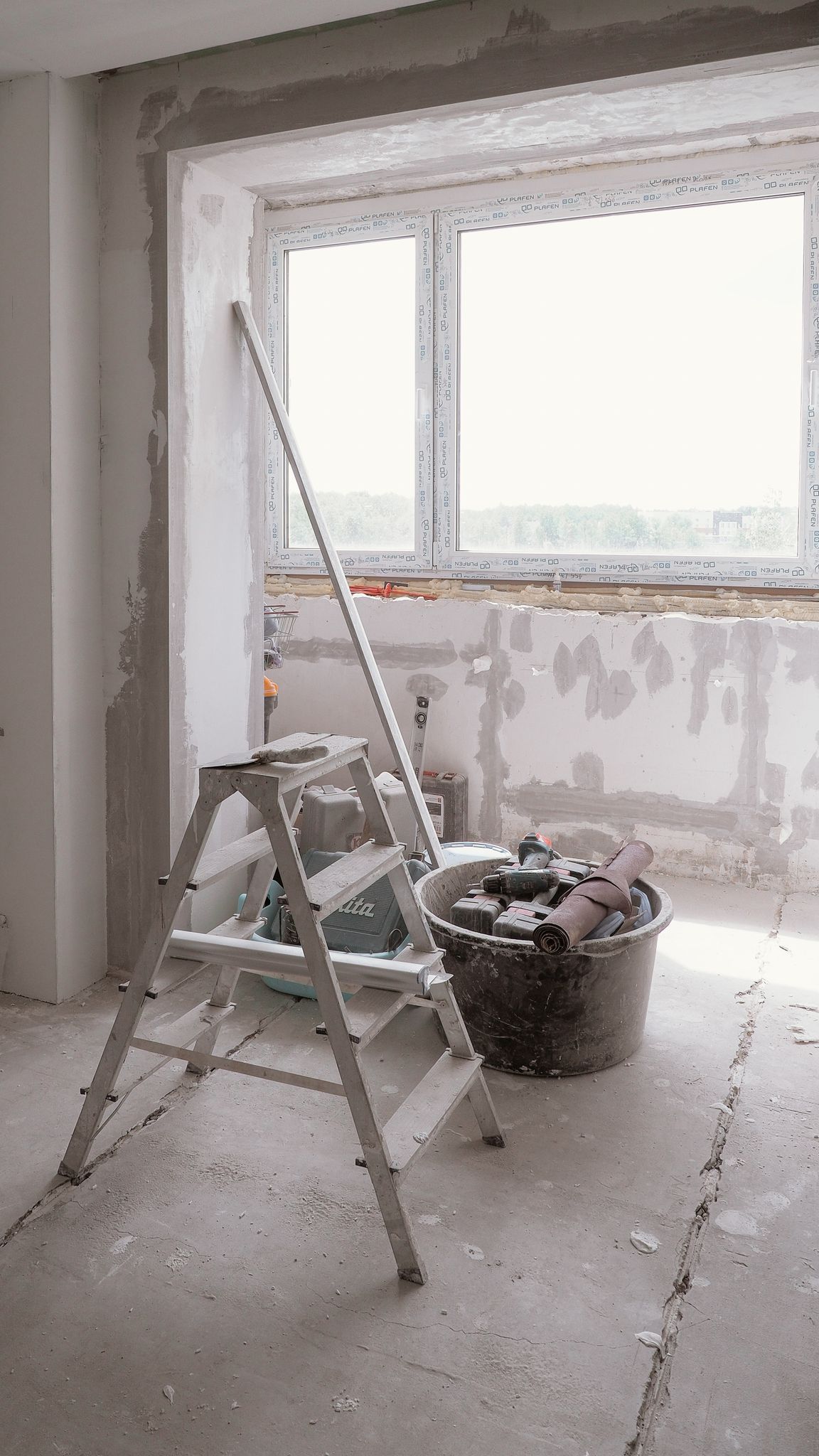 Sunlit room under renovation with tools and ladder, embodying modern DIY projects